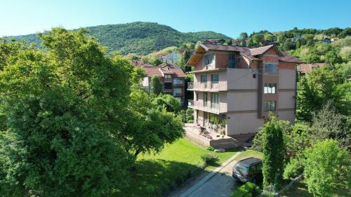 a large house with a car parked in front of it at Guest House Dimitrije in Niška Banja