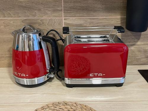 a red toaster sitting next to another red toaster at Apartmány Kašper in Levoča