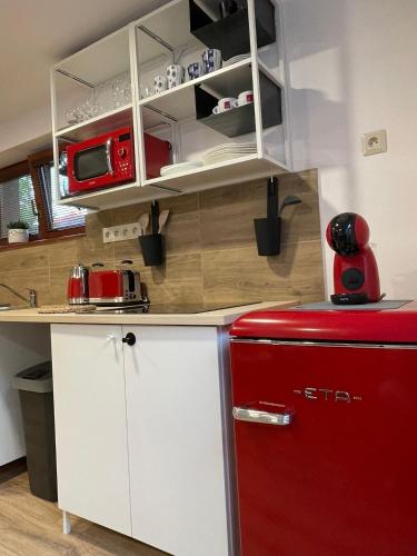 a kitchen with a red refrigerator in a room at Apartmány Kašper in Levoča