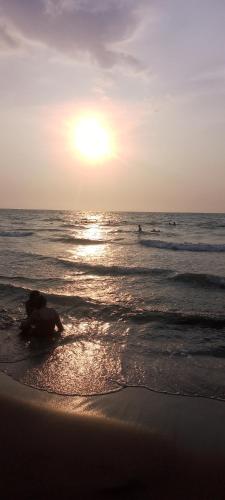 a person laying on the beach at the ocean at Hotel El Puerto in Tolú
