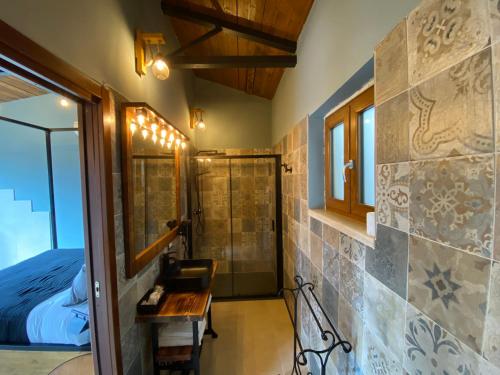 a bathroom with a shower and a bed and a table at Il Nido del Falco in Castel Gandolfo