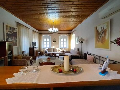 a living room with a table with a candle on it at MetaxiasAndMariasHouse in Leonidion