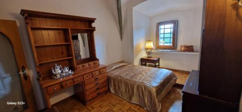 a bedroom with a bed and a dresser and a window at Burg Hermannstein - Monks Room in Wetzlar