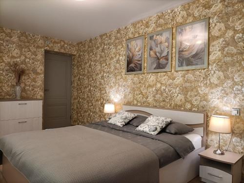 a bedroom with a bed with two lamps on it at Apartamentai Šviesa 2 in Palanga