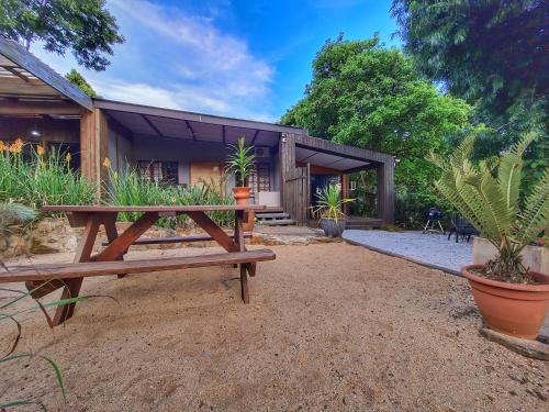 a wooden picnic table in front of a house at The Elements in Graskop
