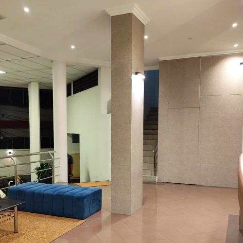 a living room with a blue couch in a building at Aurora Court Service Apartment in George Town
