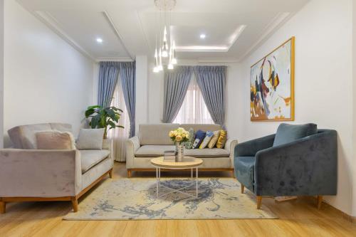 a living room with two couches and a table at Tastefully furnished 3 bedroom apartment in Lekki