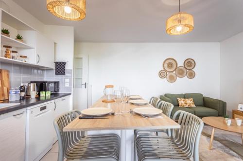 a kitchen and dining room with a table and chairs at T3 Universités & Hospitals - Havre de paix près Toulouse - parking - terrasse in Toulouse