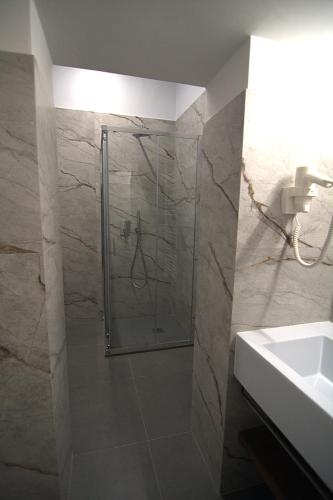 a bathroom with a shower and a sink at Giuliani Rooms in Ancona