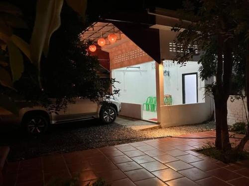 a car parked in front of a house at night at Mangifrata in Battambang