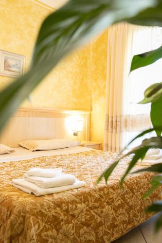 a hotel room with a bed and a window at Mannu Hotel in Bosa