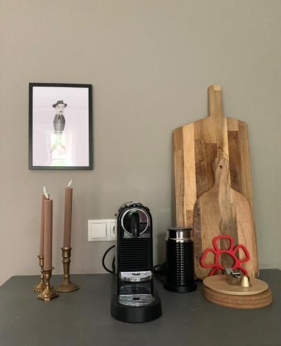 a table with a coffee maker and two candles at Amazing Spot in the Heart of Akureyri in Akureyri
