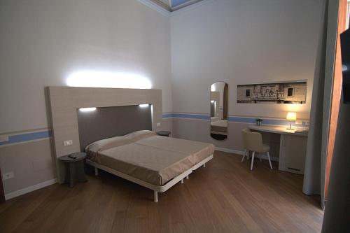 Postel nebo postele na pokoji v ubytování Giuliani Rooms