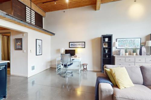 a living room with a couch and a desk at 19th Avenue Lofts Unit 213 in Seattle