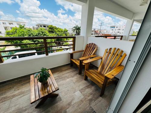two chairs on a balcony with a view of the city at Vista Bayahibe Paradise in Bayahibe