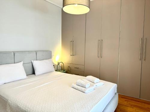 a bedroom with a bed with towels on it at Be My Guest in Tríkala