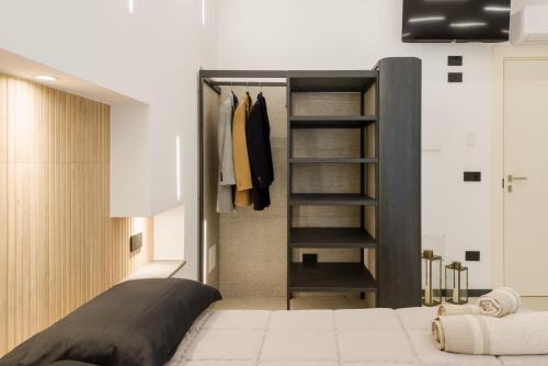 a bedroom with a bed and a closet at Sunway Luxury Apartment in Alghero