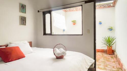 a bedroom with a bed with a shoe on it at Hotel Verona Villa de Leyva in Villa de Leyva