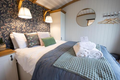 a bedroom with a bed with towels on it at The Love Shack in Otterburn