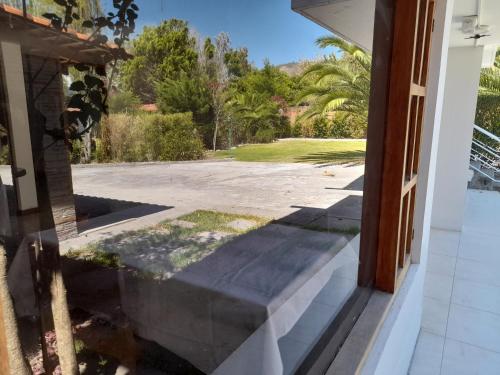 an open door of a house with a driveway at Bamboo Village Place in Tumbaco
