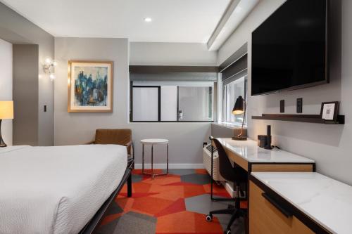 a hotel room with a bed and a desk with a computer at Infinity Hotel San Francisco, Tapestry Collection by Hilton in San Francisco
