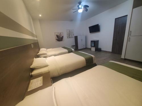 Un ou plusieurs lits dans un hébergement de l'établissement Hotel Cultura Plaza