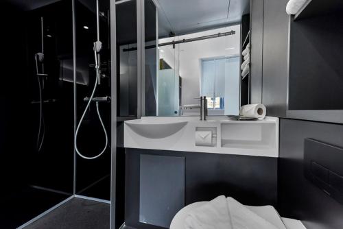 a bathroom with a sink and a shower at The Z Hotel Holborn in London