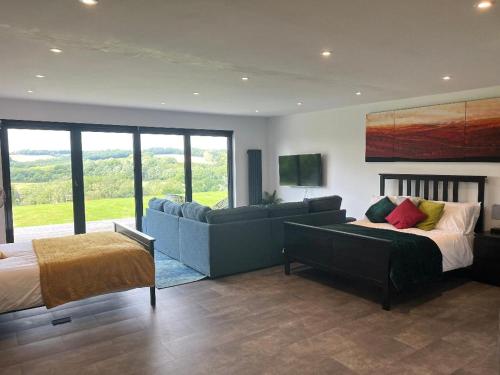a living room with a bed and a couch at The Pod in Crowhurst