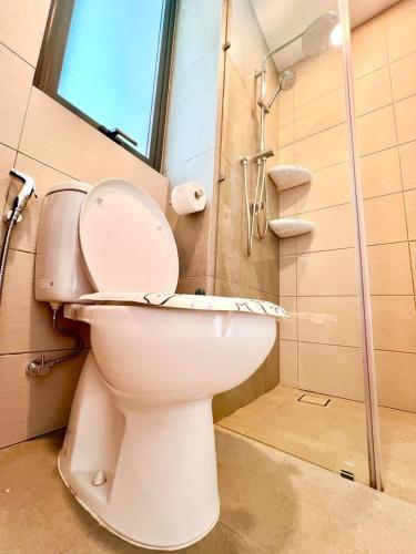 a white toilet in a bathroom with a shower at Legoland-3mins Drive KUROMI FAMIY SUITE in Iskandar Puteri