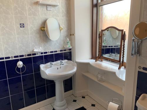 a bathroom with a sink and a mirror at High Street 2 Bedroom Apartment in Ayr