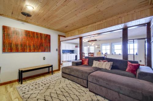 a living room with a couch and a painting on the wall at Hot Tub and Dock Lake Ozark Vacation Home! in Lake Ozark