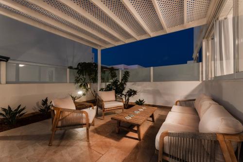 a living room with a couch and chairs and a table at Villa Atlántica - Heated pool in Playa Blanca in Playa Blanca