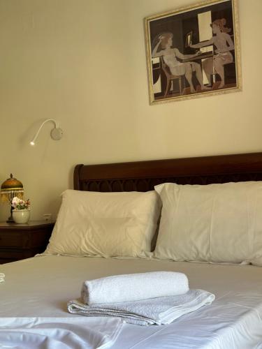 a bed with two towels sitting on top of it at Sunny Holiday in Sarandë