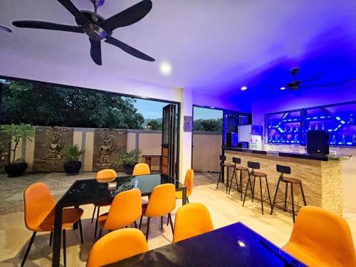 a patio with a bar and a table and chairs at patong v hotel in Patong Beach