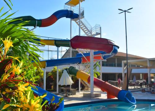 a colorful water slide in a swimming pool at Nobreza Fiori Turismo em Caldas Novas Diroma Fiori SEM ROUPAS DE CAMA BANHO E REFEIÇÕES A SEREM CONTRATADAS SEPARADAMENTE DA RESERVA in Caldas Novas