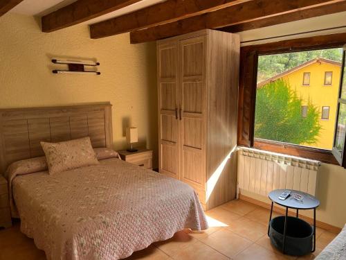 a bedroom with a bed and a large window at LA CASONA DE PALMIRA in Caín