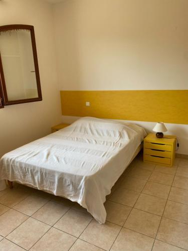 a bedroom with a bed with a mirror and a nightstand at GRANDE VILLA TIZZANO A 200 M DE LA PLAGE 18 PERS in Sartène