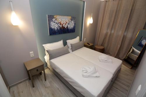 a small bedroom with a white bed in it at Chic Living 3 in Kavala