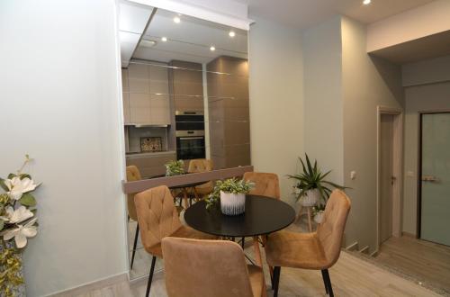 a dining room with a table and chairs at Chic Living 3 in Kavala