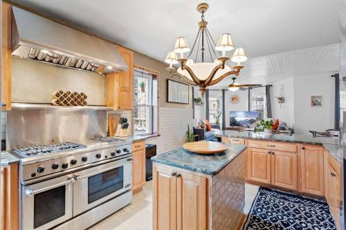 a large kitchen with wooden cabinets and a chandelier at 5BD 3BA near Hard Rock Ocean & Boardwalk in Atlantic City
