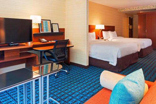 a hotel room with two beds and a desk with a television at Fairfield Inn and Suites Chicago Downtown-River North in Chicago
