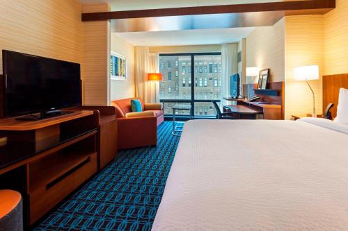 a hotel room with a bed and a flat screen tv at Fairfield Inn and Suites Chicago Downtown-River North in Chicago