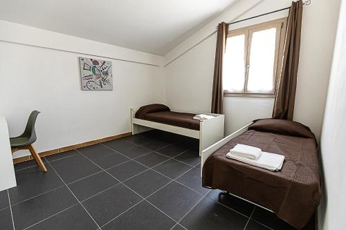 a small bedroom with a bed and a window at Home Sweet Home - La tua Oasi a Monreale in Monreale