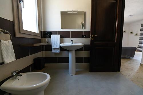 a bathroom with a sink and a toilet and a mirror at Home Sweet Home - La tua Oasi a Monreale in Monreale