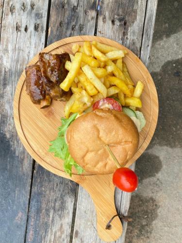 a plate of food with a sandwich and french fries at Nteto guesthouse in Dwarsloop