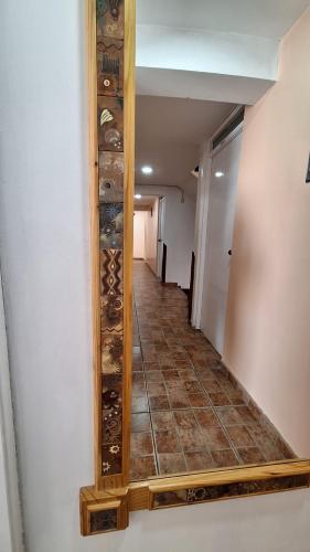 a mirror hanging on a wall with a hallway at kuntur inn hotel in Puno