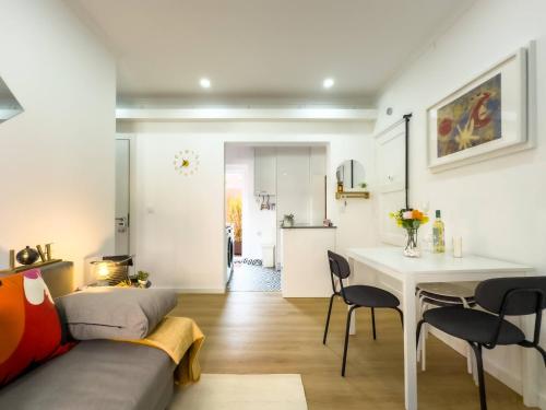 a living room with a couch and a table at River 2-Bedroom Apartment with Terrace in Alcântara in Lisbon