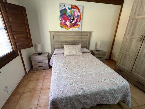 a bedroom with a bed and two night stands at LA CASONA DE PALMIRA in Caín