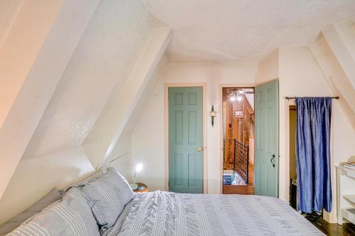 a bedroom with a bed and a staircase at A-Frame Cabin with Furnished Deck in Becket! in Becket