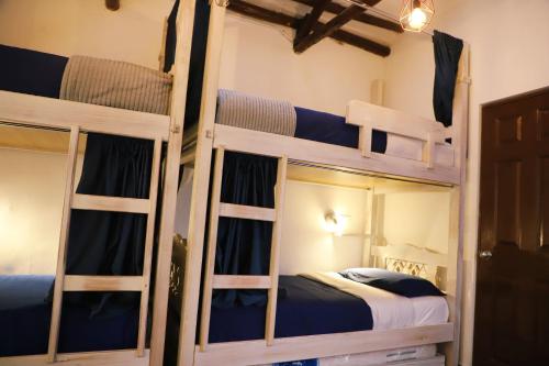 a room with three bunk beds in a room at Usaquen Station Hostel in Bogotá